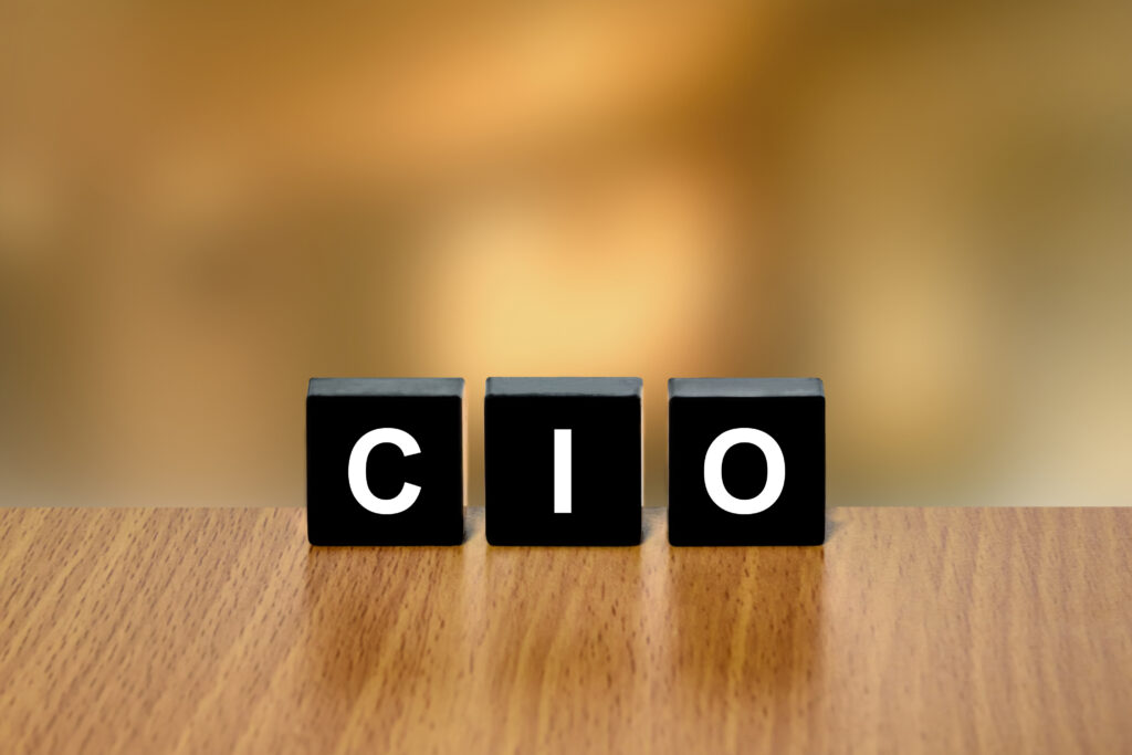 CIO or Chief investment officer on black block with blurred background